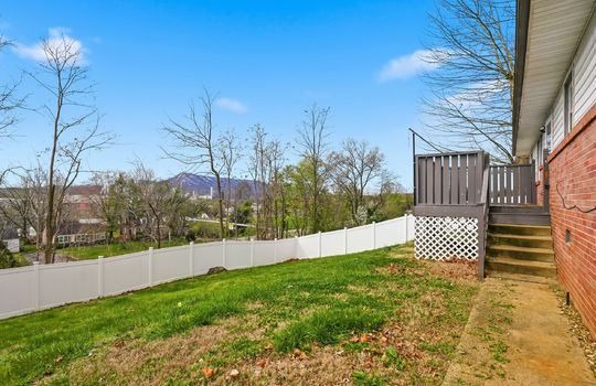 fenced back yard, back deck, stairs to back deck, exterior entry door, mountain and city views, brick, vinyl siding