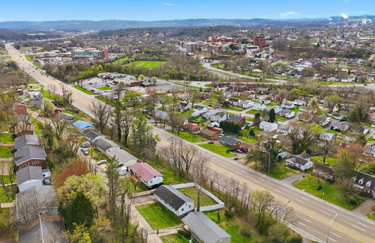 aerial photo of home, neighborhood, neighboring homes, highway, nearby businesses, streets, mountain views