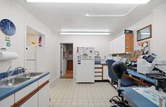 office, workstation, storage cabinets, sink, fluorescent lighting, refrigerator, testing equipment