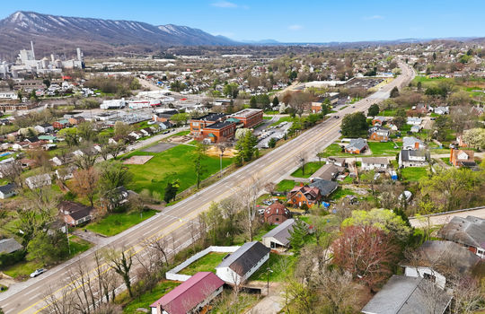 aerial photo of home, neighborhood, neighboring homes, highway, nearby businesses, streets, mountain views