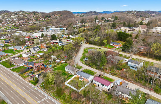 aerial photo of home, neighborhood, neighboring homes, highway, nearby businesses, streets, mountain views