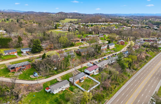 aerial photo of home, neighborhood, neighboring homes, highway, nearby businesses, streets, mountain views