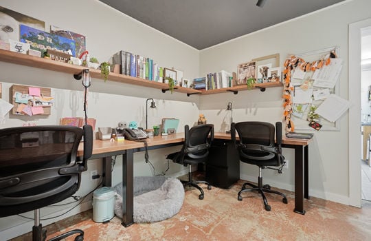 private office space, desk, shelving, concrete flooring, track lighting