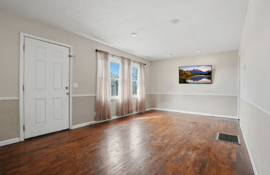living room, hardwood flooring, windows, recessed lighting, exterior door