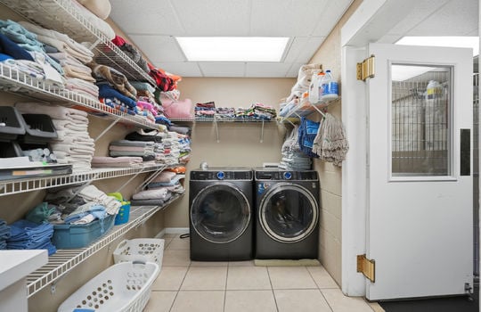 laundry area, storage shelves, washer/dryer hookups, tile flooring