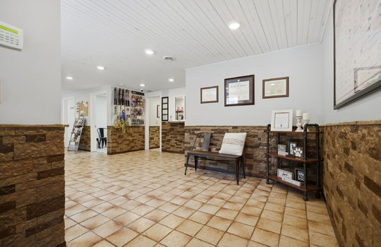 waiting/reception area, tile flooring, stone wall design, recessed lighting