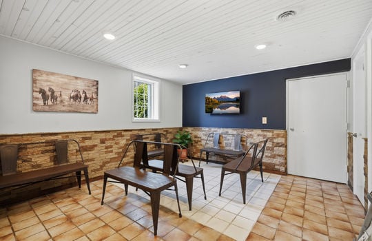waiting area, tile flooring, doorway to exam rooms, stone wall design, recessed lighting, window