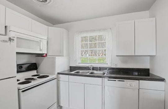 kitchen, cabinets, countertops, sink, window above sink, refrigerator, microwave, range, dishwasher