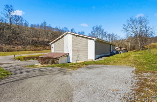 view of veterinary office and barn from upper driveway area, driveway, road, trees
