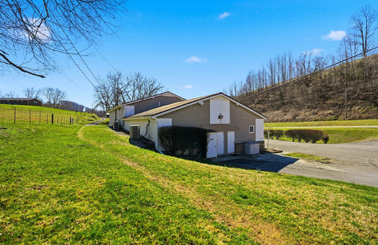 side view of veterinary clinic, entry doors, vinyl siding, metal siding, parking lot