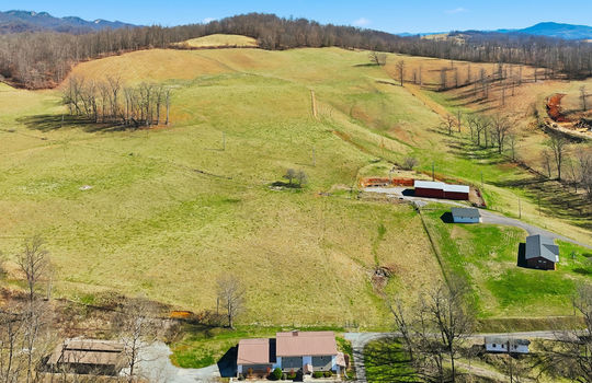 aerial view of veterinary office and land, mountain views, surrounding properties