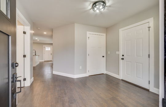 front door, living room, doors, laminate flooring, hallway