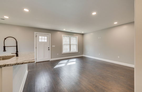 kitchen/dining combo, exterior door, recessed lighting, kitchen island, laminate flooring