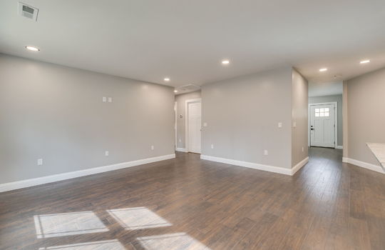 kitchen dining combo, dining area, recessed lighting, view into living room/entryway, front door, hallway
