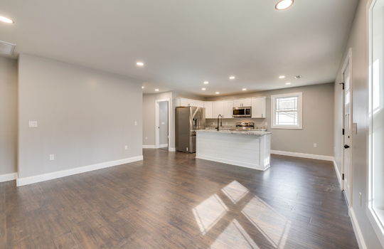 kitchen/dining combo, kitchen, kitchen island, stainless appliances, refrigerator, built-in microwave, range, sink in island, exterior door