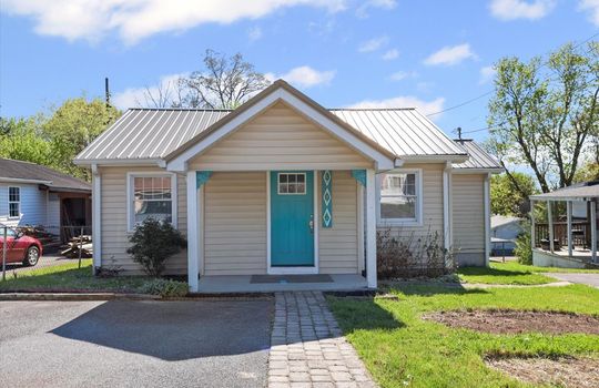 cottage, driveway, covered front porch, front door, front yard, vinyl siding, metal roof