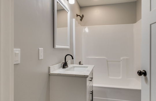 second bathroom, tile flooring, tub/shower, sink