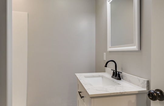 third bathroom, shower, sink, tile flooring