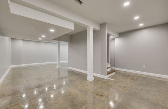 finished basement, concrete flooring, stairs to main level, recessed lighting
