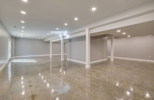 finished basement, concrete flooring, exterior door, recessed lighting