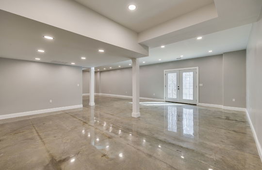 finished basement, concrete flooring, exterior door, recessed lighting