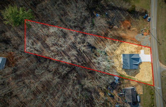 aerial view of home, roaad, driveway, roof, front yard, back yard, creek, back deck, property outline