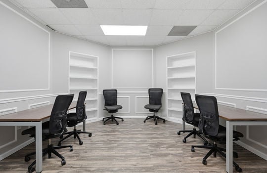 office space, built in shelving, luxury vinyl flooring, decorative trim, ceiling tiles, fluorescent lighting