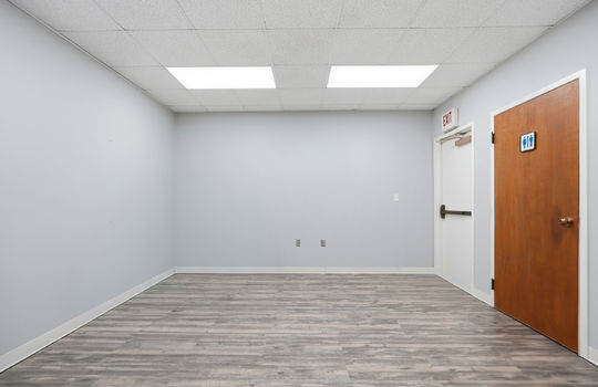 secondary office space, luxury vinyl flooring, ceiling tiles, fluorescent lighting, private bathroom, back exit door
