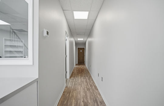 hallway, fluorescent lighting, doors to offices, door to bathroom,