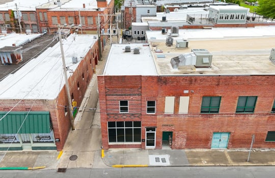 aerial view of commercial rental space, for lease, brick exterior, roof, alleyway, road, sidewalk, glass entry door, glass window, two stories