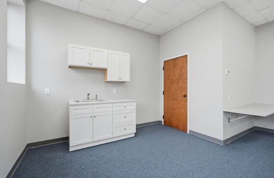 sink, cabinets, storage/utility closet, carpet, window