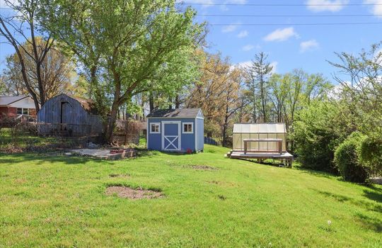 Back yard, storage shed, greenhouse, fencing, trees