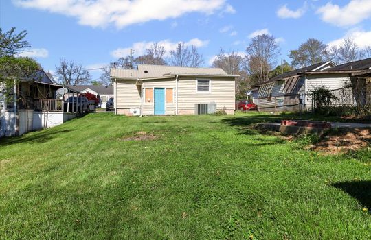 back of home, vinyl siding, exterior entry door,