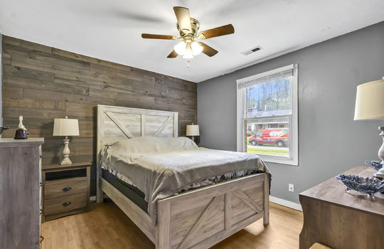 bedroom, wood feature wall, ceiling fan, window, luxury vinyl flooring