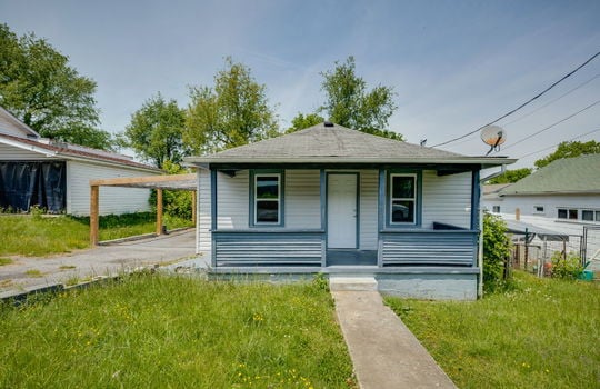 bungalow/cottage, covered front porch, sidewalk, front door, front yard, vinyl siding