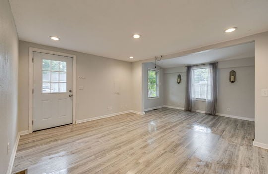 living room, front door, dining area, recessed lighting, laminate flooring