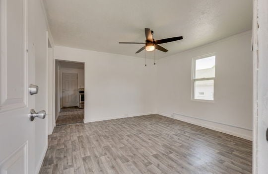 living room, laminate flooring, ceiling fan, window