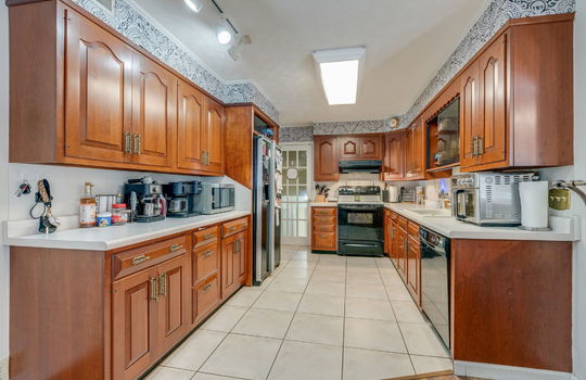 kitchen, tile flooring, cabinets, countertops, refrigerator, dishwasher, electric range, sink
