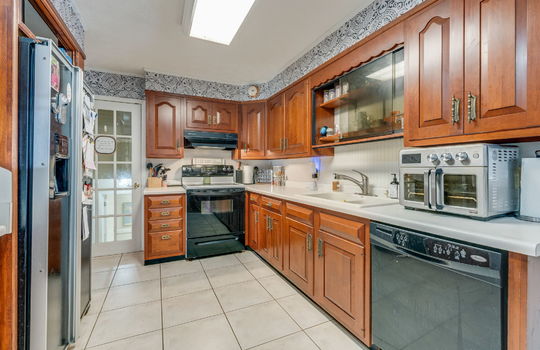 kitchen, tile flooring, cabinets, countertops, refrigerator, dishwasher, electric range, sink