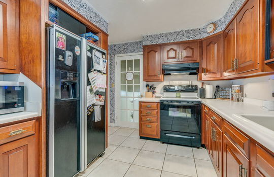 kitchen, tile flooring, cabinets, countertops, refrigerator, electric range, sink