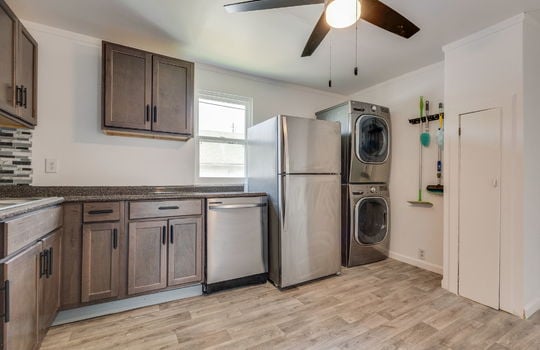kitchen, laminate flooring, washer/dryer hookups, refrigerator, dishwasher, cabinets, countertops, window, sink, ceiling fan