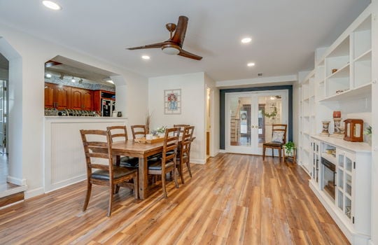 dining room, built-in shelving, hardwood flooring, french doors, ceiling fan