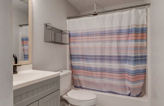 bathroom, sink, toilet, shower/tub, laminate flooring