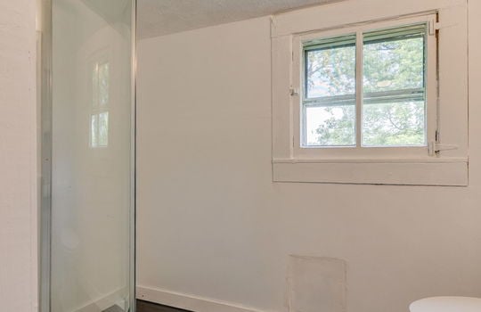 bathroom, walk-in shower, toilet, laminate flooring, window