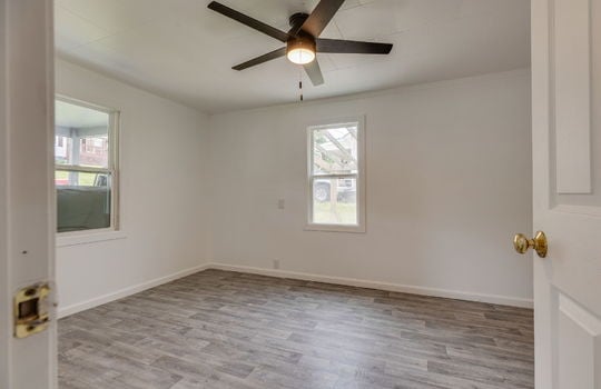 bedroom, ceiling fan, laminate flooring, windows