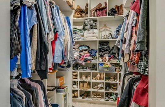 walk-in closet, custom shelving, tile flooring