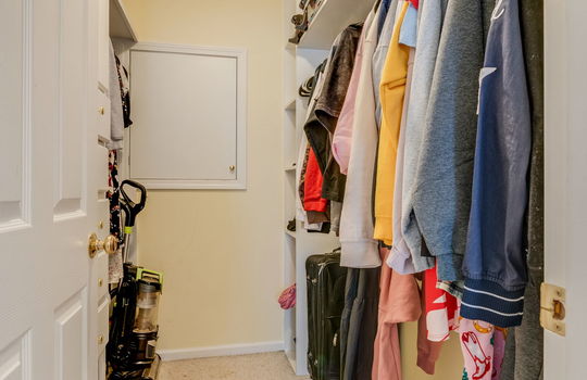 walk-in closet, carpet, custom shelving
