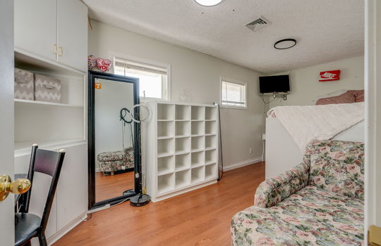 bedroom, hardwood flooring, built-in shelving, windows