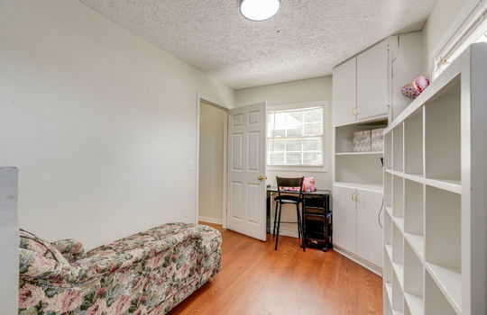 bedroom, built-in shelving, hardwood flooring, window