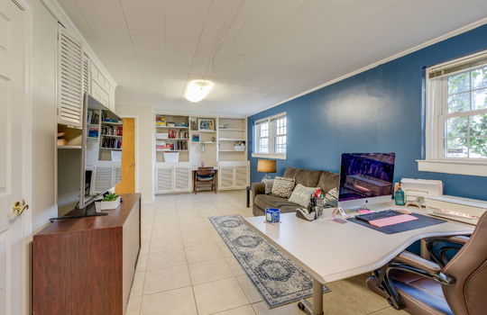 den, storage closets, tile flooring, built-in shelving, windows
